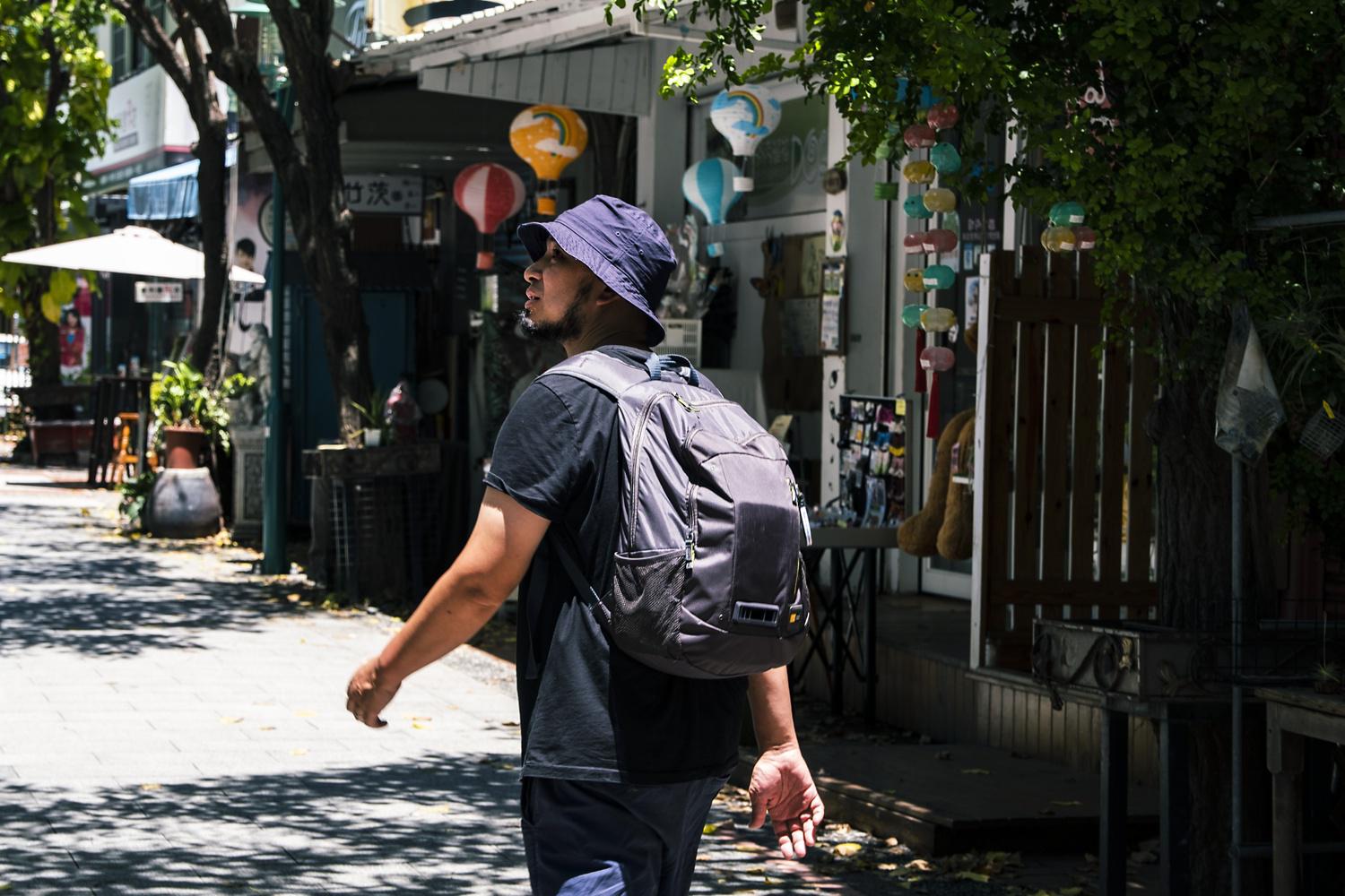 Alex Lam walks the streets of Taiwan using the Dyson Air Quality Backpack.